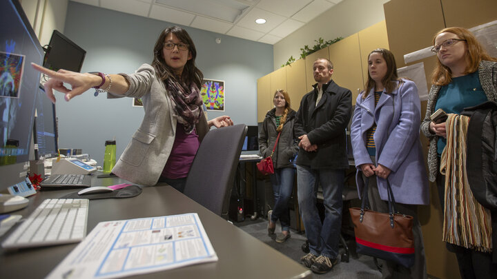 Maital Neta, assistant professor of psychology, demonstrates to legislative staff the MRI machine in Nebraska's Center for Brain, Biology and Behavior on Nov. 30.