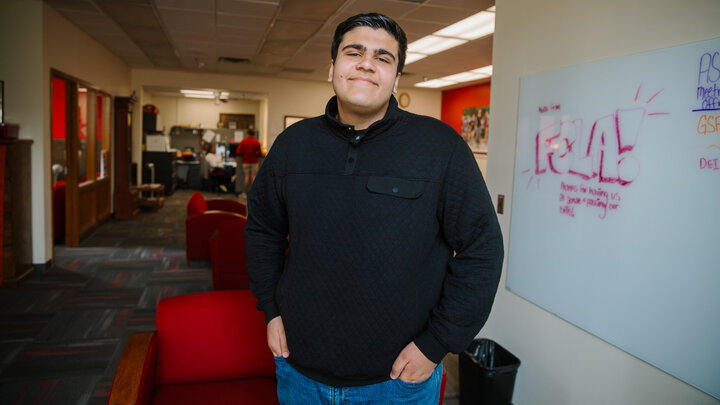 Zein Saleh stands in an office.