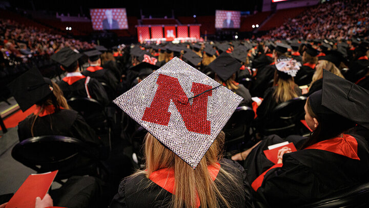 Student with decorated cap in the crowd at a previous commencement